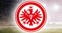 Das Logo von Eintracht Frankfurt und im Hintergrund ein Stadion.