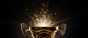 Ein goldener Pokal mit Funken vor einem schwarzen Hintergrund.